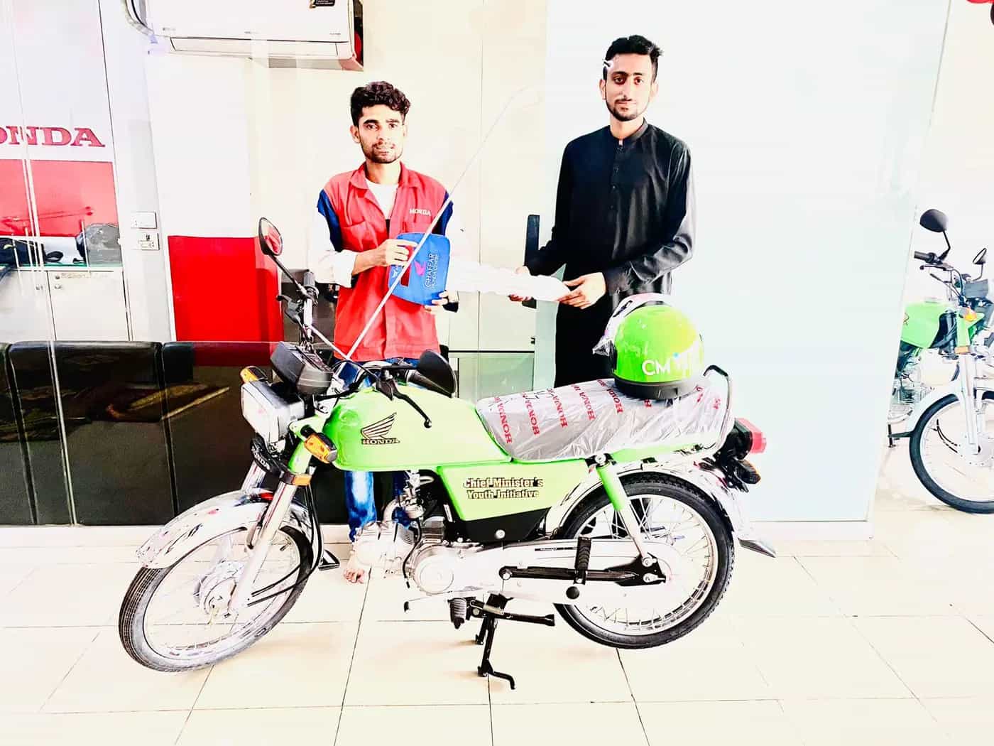Students collecting their new scheme bikes from an authorized dealer in Punjab