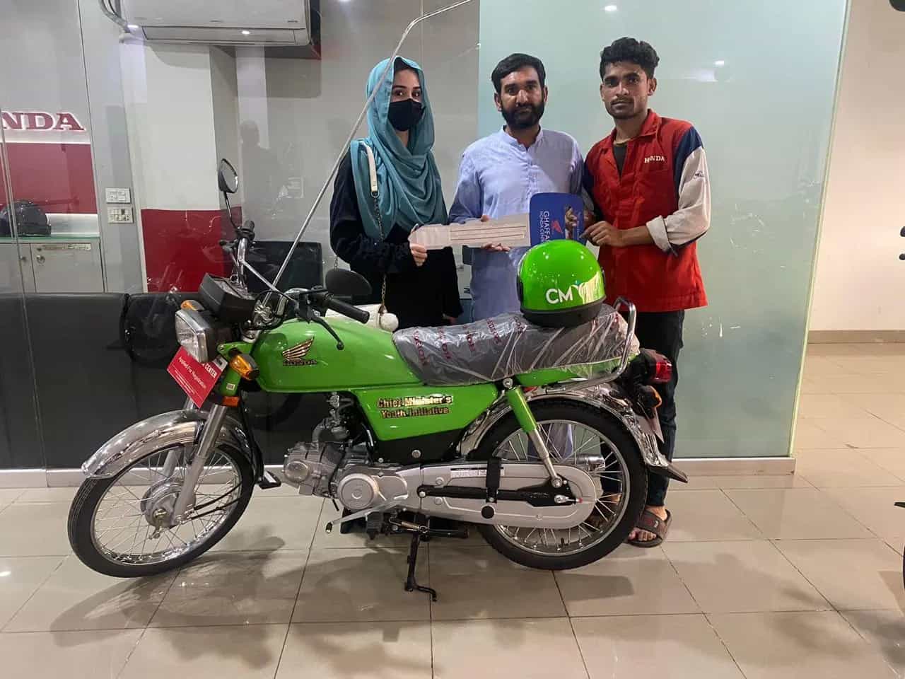 Happy students with their newly delivered scheme motorcycles