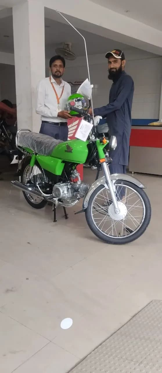 A helmeted beneficiary ready to ride his new scheme bike home