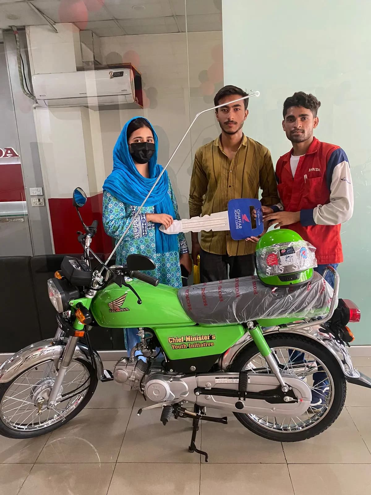 A government school teacher receiving her subsidized e-bike under the PTF program