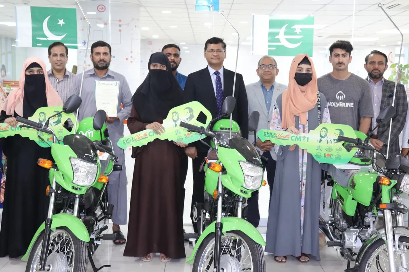 A proud owner holding his bike documents after completing all installments