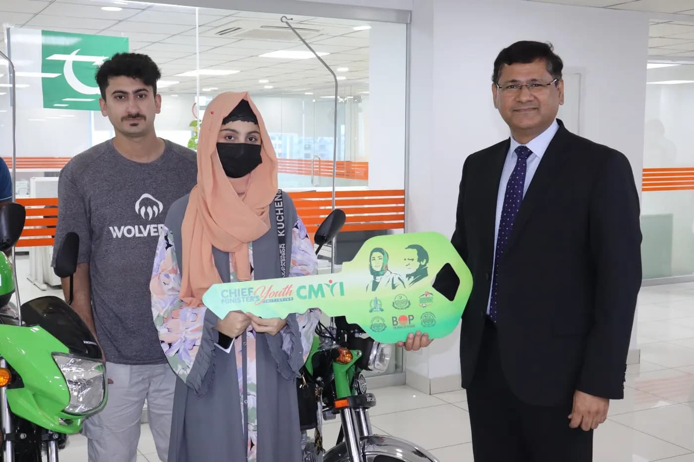 A family collecting their scheme bike and installment paperwork at the dealership